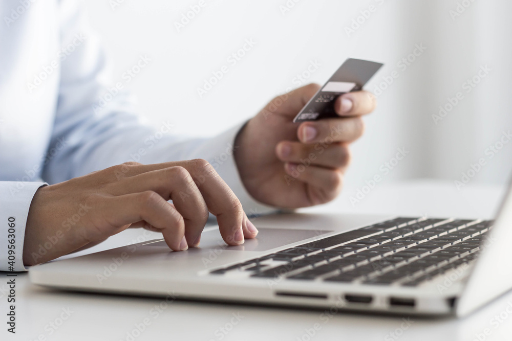 Asian women are filling out credit card information on their laptops to pay for purchases made on the Internet using credit cards. Asian women are filling out credit card information on their laptops to pay for purchases made on the Internet using credit cards.