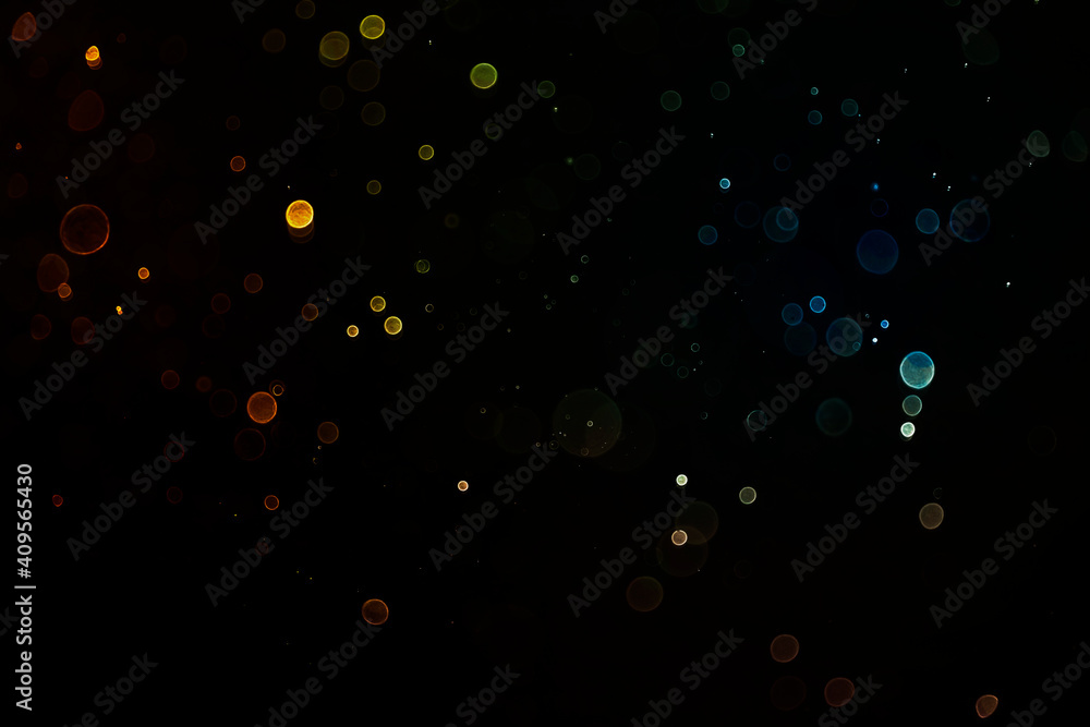 Abstract gold glitter explosion on bokeh black background