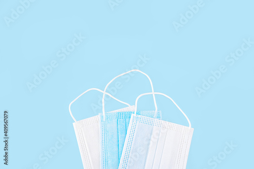 Medical white and blue mask isolated on blue background, Corona protection photo