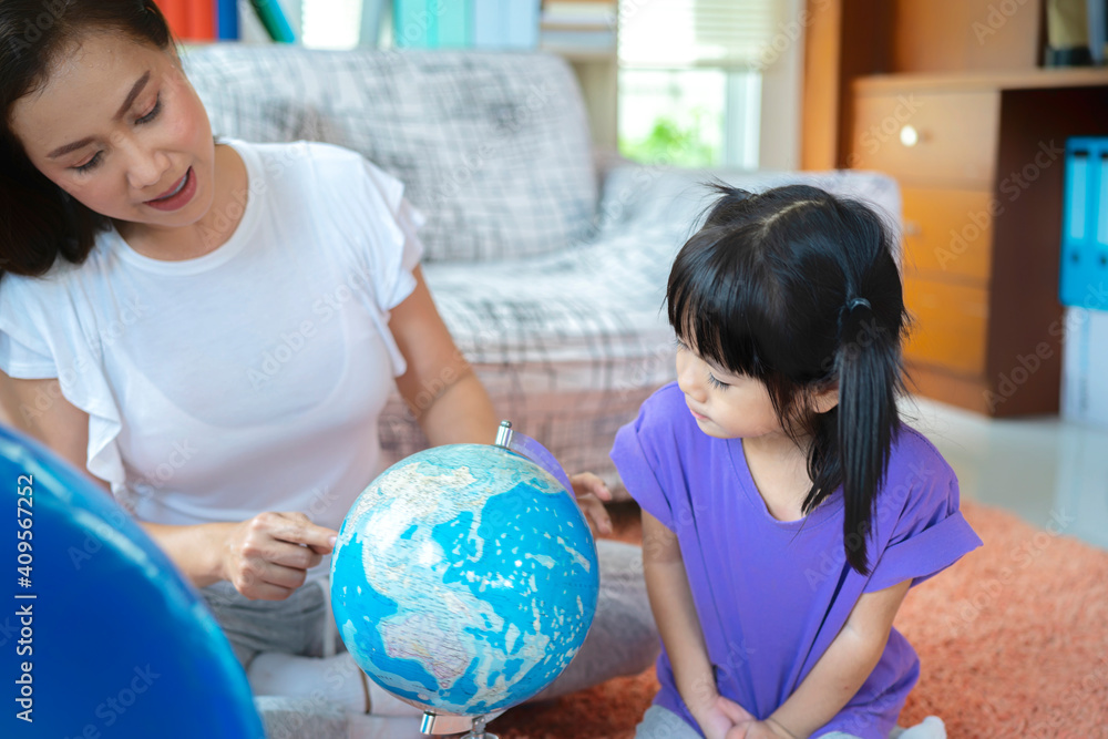 pretty family homeschooling mother happy teaching smart daughter private lessons in globe. pretty family homeschooling mother happy teaching smart daughter private lessons in globe.