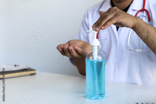 Doctors are using an alcohol-based hand sanitizer to prevent COVID-19. Use an antibacterial alcohol gel. Concept of prevention of COVID-19.