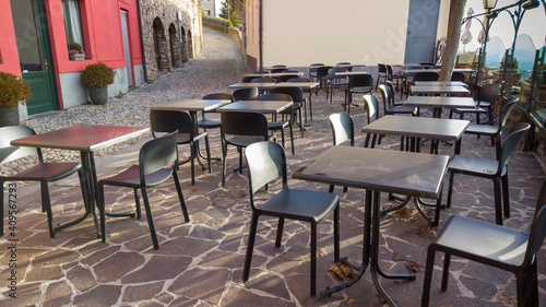 Bergamo  Italy. Empty bar tables due to the Covid-19 or Coronavirus pandemic. Light lockdown time. Bars and restaurants closed due to the absence of tourists. Desolation and sadness for empty city