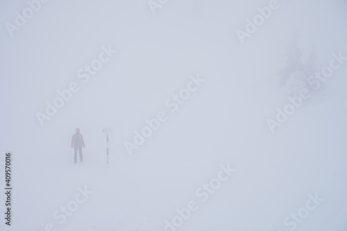 Obraz na płótnie Hiker on a trail in Romanian Carpathian mountains with reduced visibility due to fog and snow w salonie