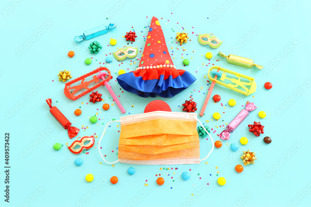 Obraz premium carnival, party and Purim celebration (jewish carnival holiday) over blue background. Coronavirus prevention concept, medical mask