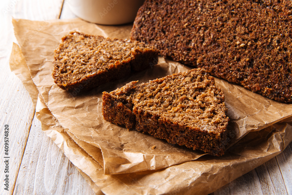 Closeup on sliced triangle flourless diet grain bread on parchment paper Closeup on sliced triangle flourless diet grain bread on parchment paper