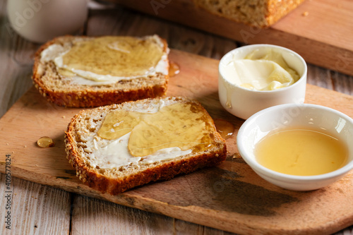 Closeup on whole grain bread slices spred with butter and honey