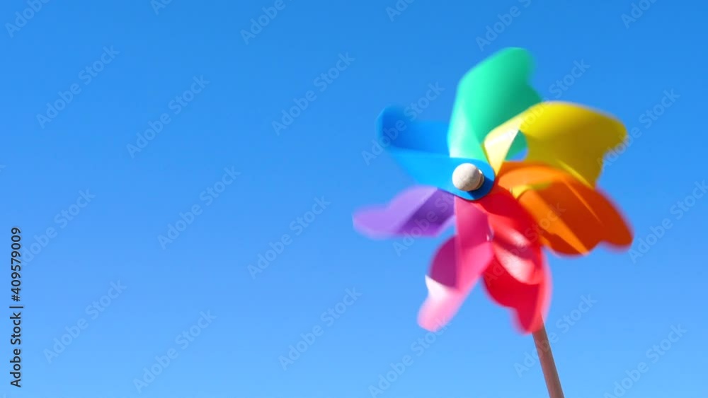 colorful paper windmill on blue sky background
colorful paper windmill on blue sky background