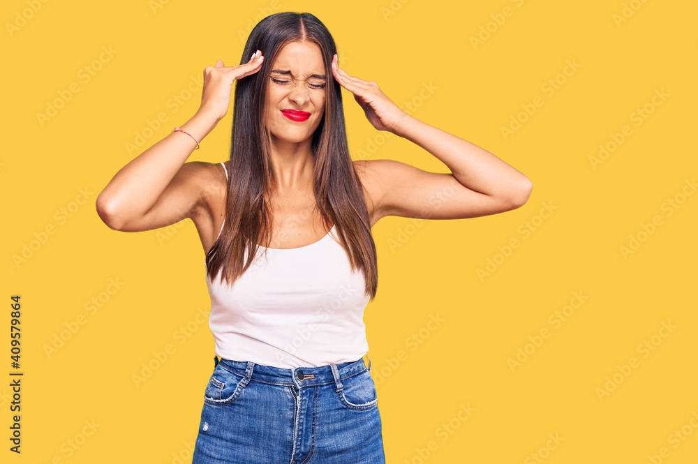 Young hispanic woman wearing casual clothes suffering from headache desperate and stressed because pain and migraine. hands on head. Young hispanic woman wearing casual clothes suffering from headache desperate and stressed because pain and migraine. hands on head.