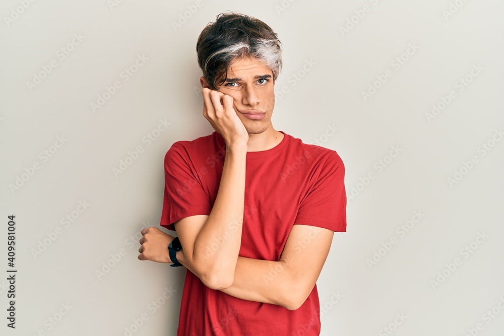 Young hispanic man wearing casual clothes thinking looking tired and bored with depression problems with crossed arms. Young hispanic man wearing casual clothes thinking looking tired and bored with depression problems with crossed arms.