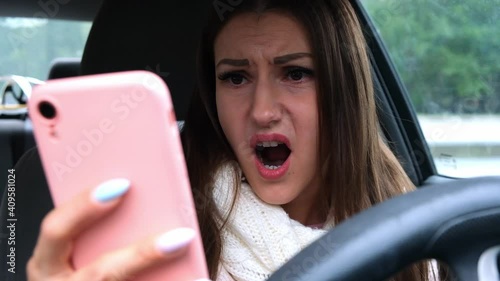 surprised upset female using smartphone on car driving. bad news concept.