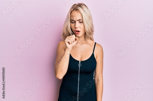 Beautiful caucasian blonde girl wearing sexy party dress feeling unwell and coughing as symptom for cold or bronchitis. health care concept.