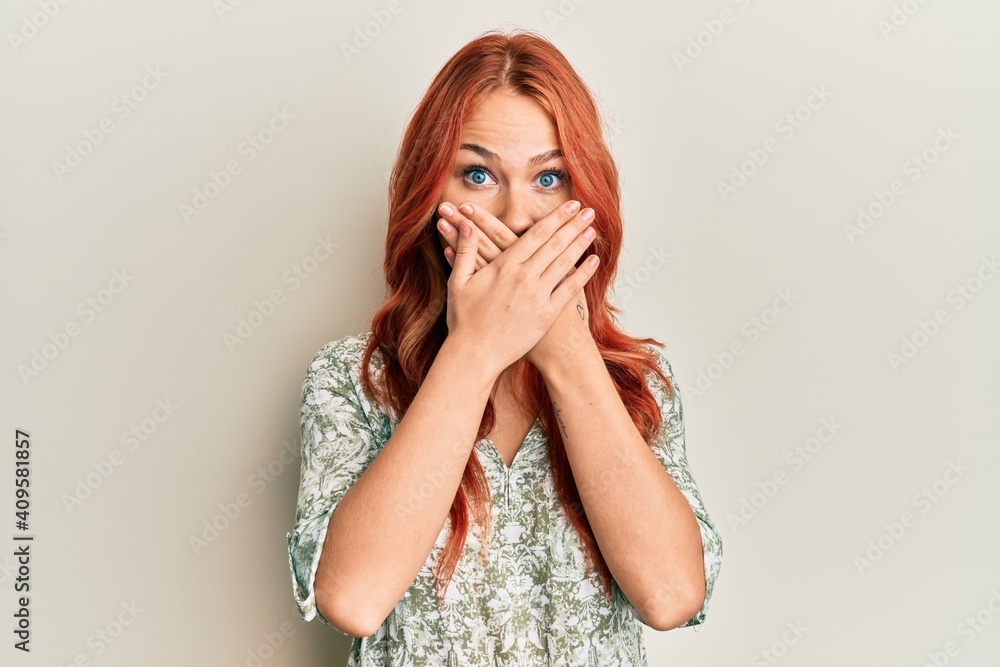 Young beautiful redhead woman wearing casual clothes shocked covering mouth with hands for mistake. secret concept. Young beautiful redhead woman wearing casual clothes shocked covering mouth with hands for mistake. secret concept.