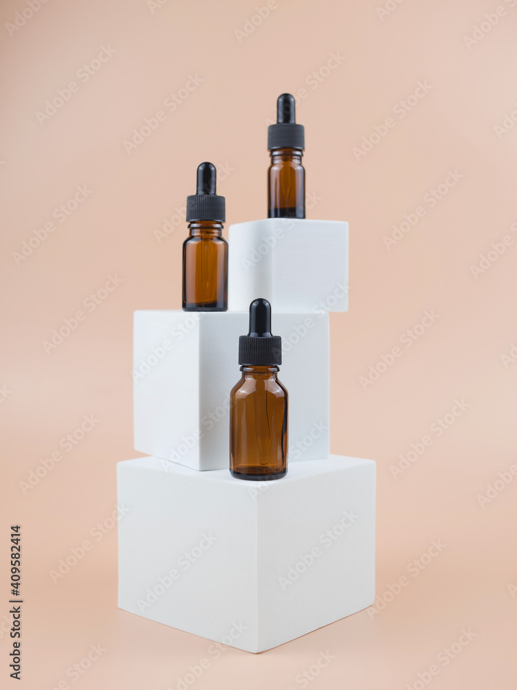 Brown glass bottles with serum, essential oil or other cosmetic product. Natural organic cosmetic packaging, skin care concept.