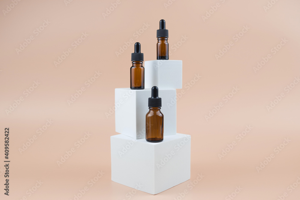 Brown glass bottles with serum, essential oil or other cosmetic product. Natural organic cosmetic packaging, skin care concept. Brown glass bottles with serum, essential oil or other cosmetic product. Natural organic cosmetic packaging, skin care concept.