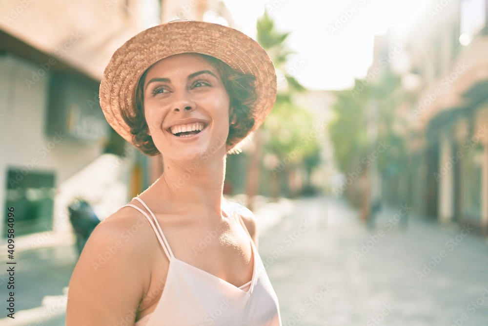 Young hispanic woman on vacation smiling happy walking at street of city