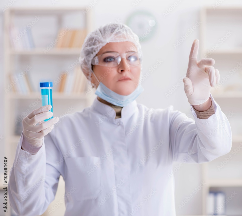 Woman chemist pressing virtual button in lab Woman chemist pressing virtual button in lab