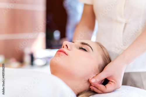 Beautiful young attractive Caucasian woman having body massage by Thai Masseur in spa salon. Beauty treatment and body care lifestyle concept 