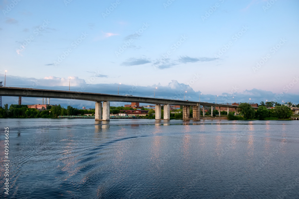 A bridge over the Kostroma river on a summer evening. View from the Ipatiev Monastery A bridge over the Kostroma river on a summer evening. View from the Ipatiev Monastery