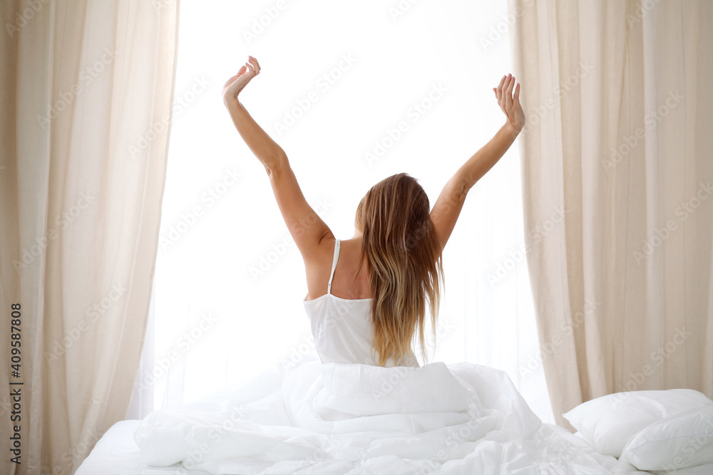 custom made wallpaper toronto digitalWoman stretching in bed after wake up, back view, entering a day happy and relaxed after good night sleep. Sweet dreams, good morning, new day, weekend, holidays concept