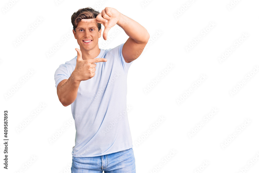 Young handsome man wearing casual clothes smiling making frame with hands and fingers with happy face. creativity and photography concept.