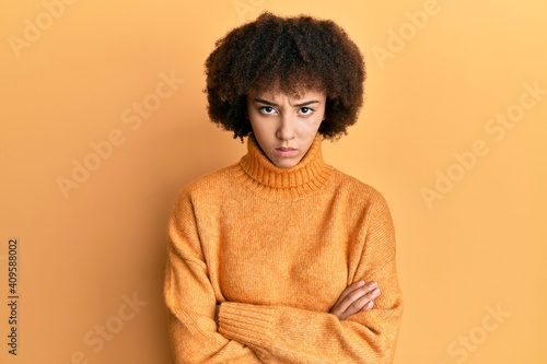 Young hispanic girl wearing wool winter sweater skeptic and nervous, disapproving expression on face with crossed arms. negative person. © Krakenimages.com