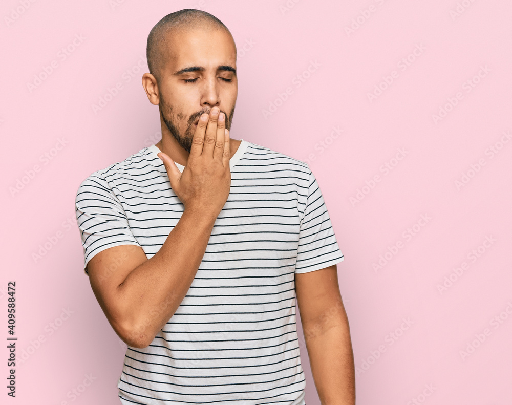 Hispanic adult man wearing casual clothes bored yawning tired covering mouth with hand. restless and sleepiness. Hispanic adult man wearing casual clothes bored yawning tired covering mouth with hand. restless and sleepiness.