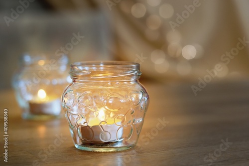 Lovely candles on the table, cozy home interior background