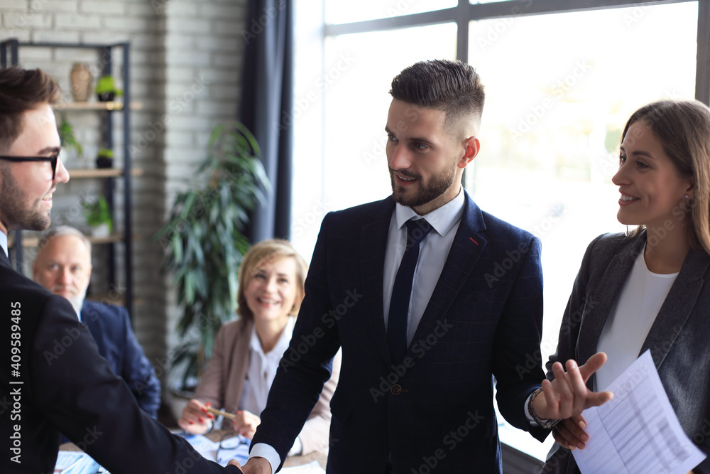 Business people shaking hands, finishing up a meeting.