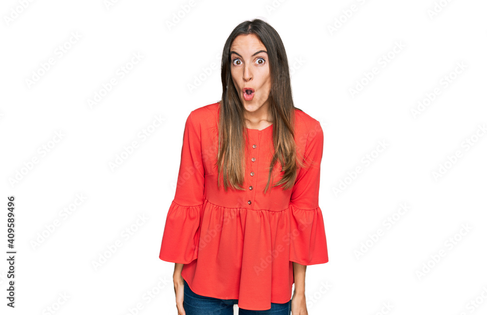 Young beautiful woman wearing casual clothes scared and amazed with open mouth for surprise, disbelief face Young beautiful woman wearing casual clothes scared and amazed with open mouth for surprise, disbelief face