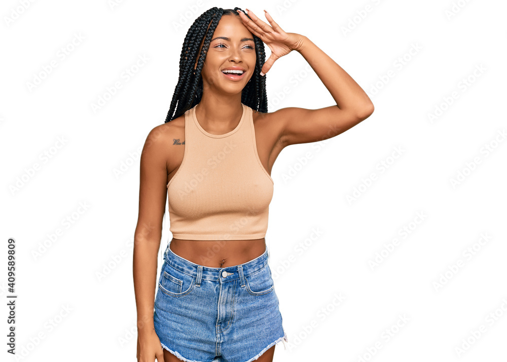 Beautiful hispanic woman wearing casual clothes very happy and smiling looking far away with hand over head. searching concept. Beautiful hispanic woman wearing casual clothes very happy and smiling looking far away with hand over head. searching concept.