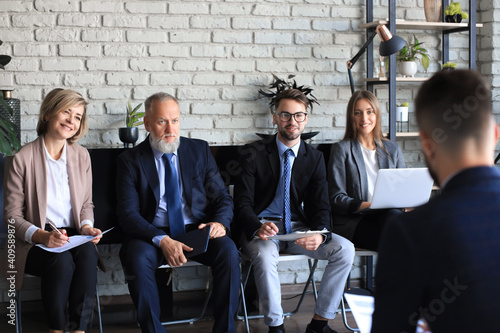 Job interview with the employer, businessman listen to candidate answers. photo