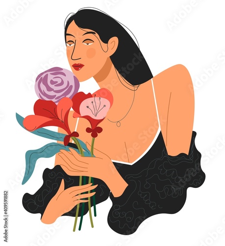 Elegant lady sniffing bouquet of flowers in hands