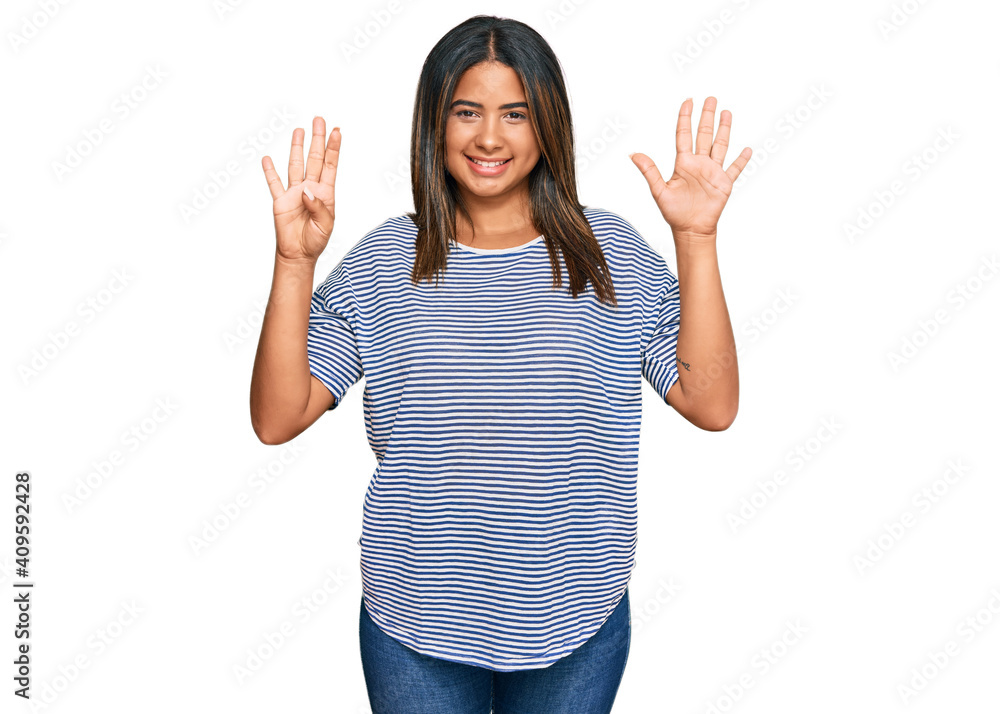 Young latin girl wearing casual clothes showing and pointing up with fingers number nine while smiling confident and happy. Young latin girl wearing casual clothes showing and pointing up with fingers number nine while smiling confident and happy.