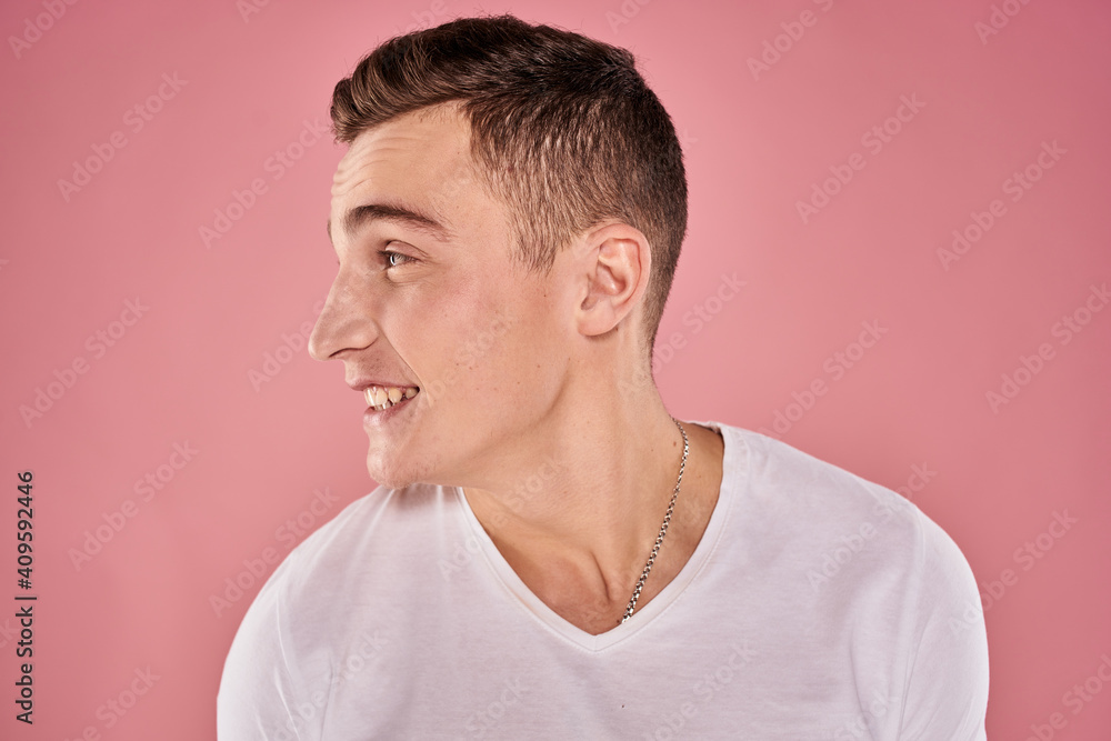 cheerful man in white t-shirt smile emotions close-up pink background studio