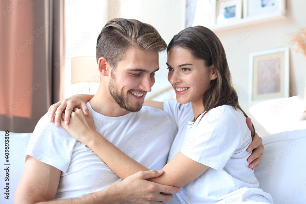 Happy young couple hugging and looking at each other at home interior. Happy young couple hugging and looking at each other at home interior.