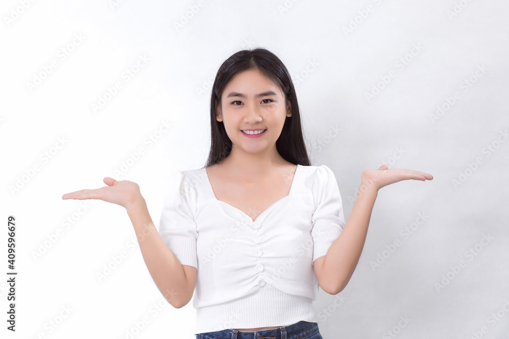 Portrait Asian woman is smiling and shows her hands to present something on the white background. Portrait Asian woman is smiling and shows her hands to present something on the white background.