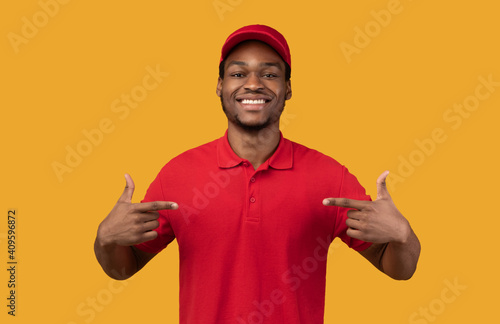 Smiling black bearded delivery man pointing at himself