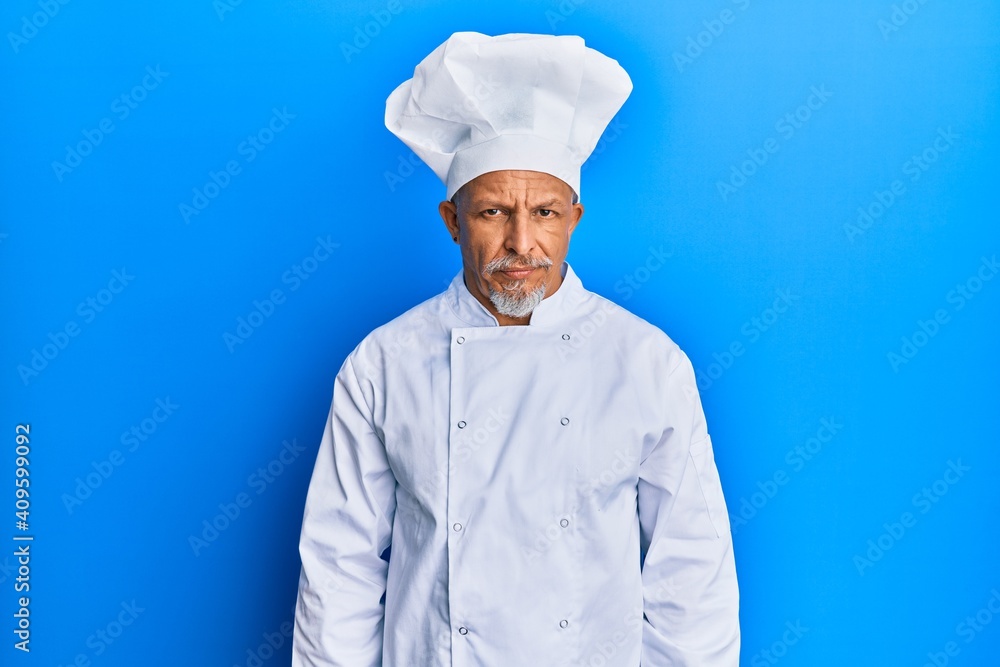 Middle age grey-haired man wearing professional cook uniform and hat skeptic and nervous, frowning upset because of problem. negative person. Middle age grey-haired man wearing professional cook uniform and hat skeptic and nervous, frowning upset because of problem. negative person.