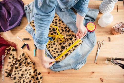 Fashion designer working in fashion workshop making handmade jacket