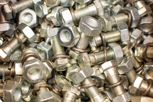 Сlose up of bright and shiny nuts, bolts and washers for mounting element car, tractor, truck, heavy machinery. Industrial background. Industrial background.