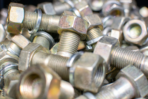 Сlose up of bright and shiny nuts, bolts and washers for mounting element car, tractor, truck, heavy machinery. Industrial background. Industrial background.