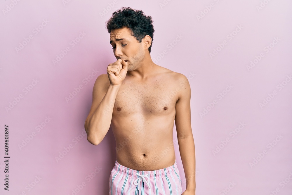 Fototapeta premium Young handsome man wearing swimwear shirtless feeling unwell and coughing as symptom for cold or bronchitis. health care concept.
