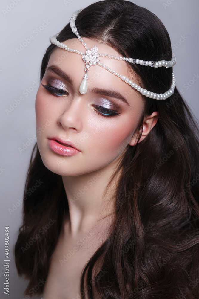 Woman with pearl jewelry on hair and evening make-up