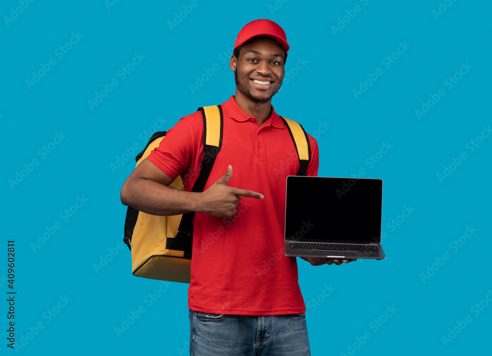 Black delivery man holding laptop with blank screen for mockup Stock ...