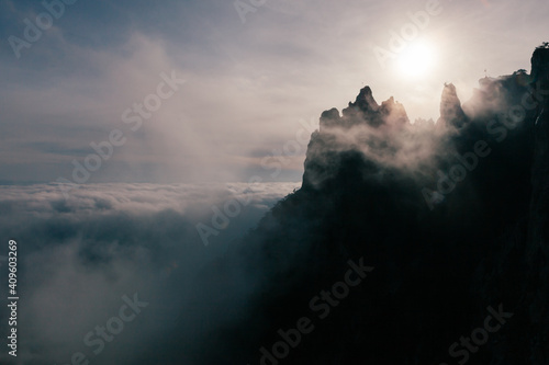 mountain peak above the clouds at the misty morning