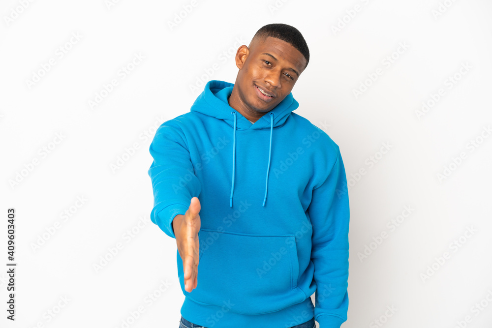 Young latin man isolated on white background shaking hands for closing a good deal Young latin man isolated on white background shaking hands for closing a good deal