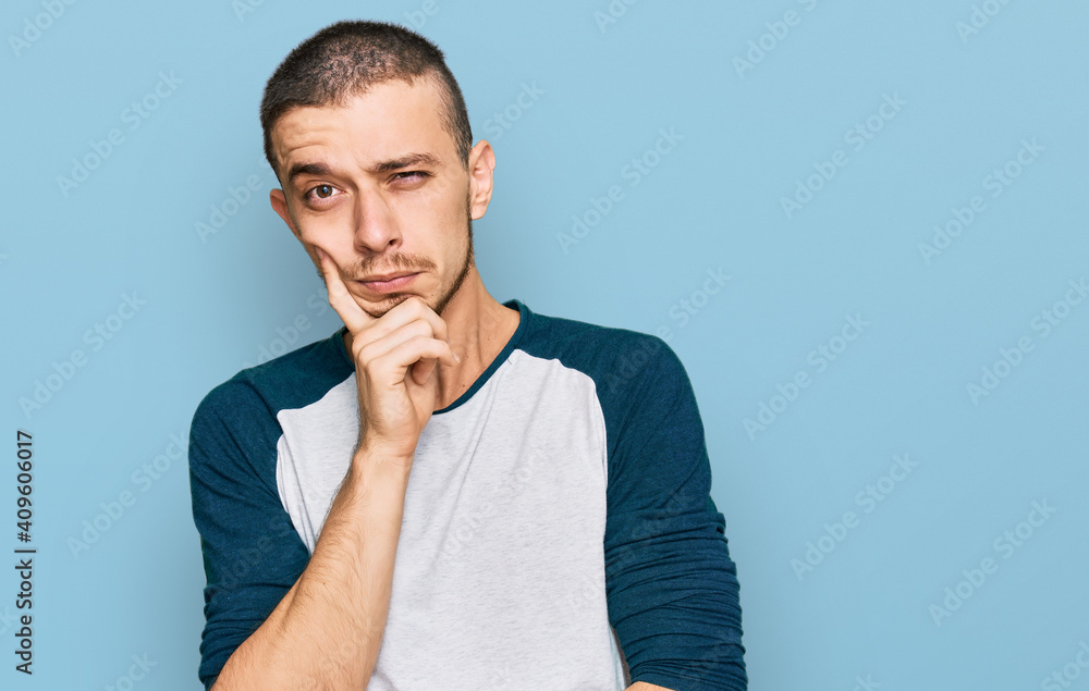 Hispanic young man wearing casual clothes thinking looking tired and bored with depression problems with crossed arms. Hispanic young man wearing casual clothes thinking looking tired and bored with depression problems with crossed arms.
