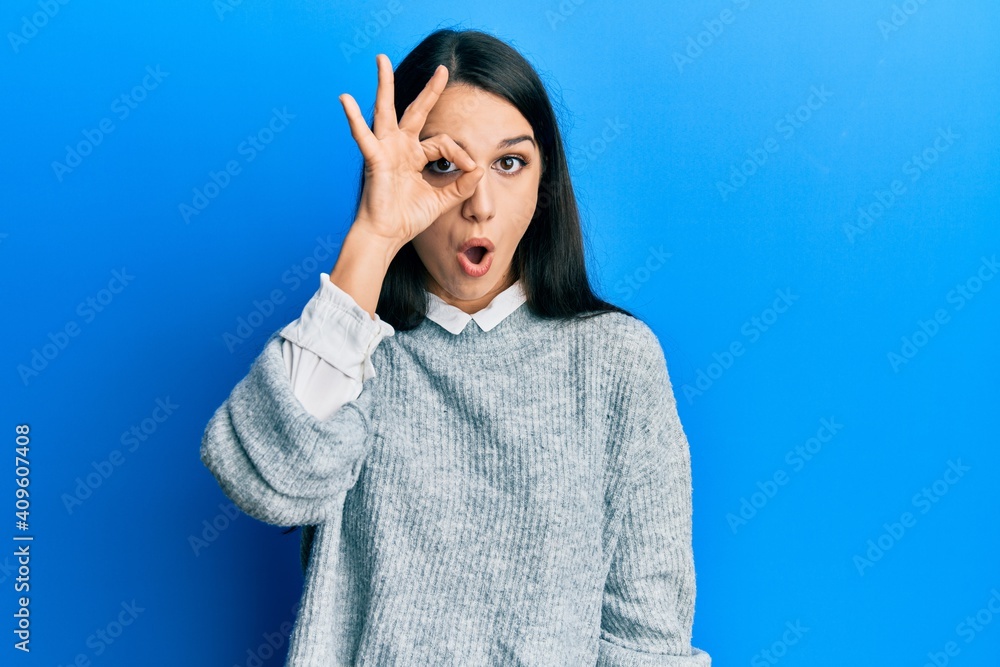 Young hispanic woman wearing casual clothes doing ok gesture shocked with surprised face, eye looking through fingers. unbelieving expression. Young hispanic woman wearing casual clothes doing ok gesture shocked with surprised face, eye looking through fingers. unbelieving expression.