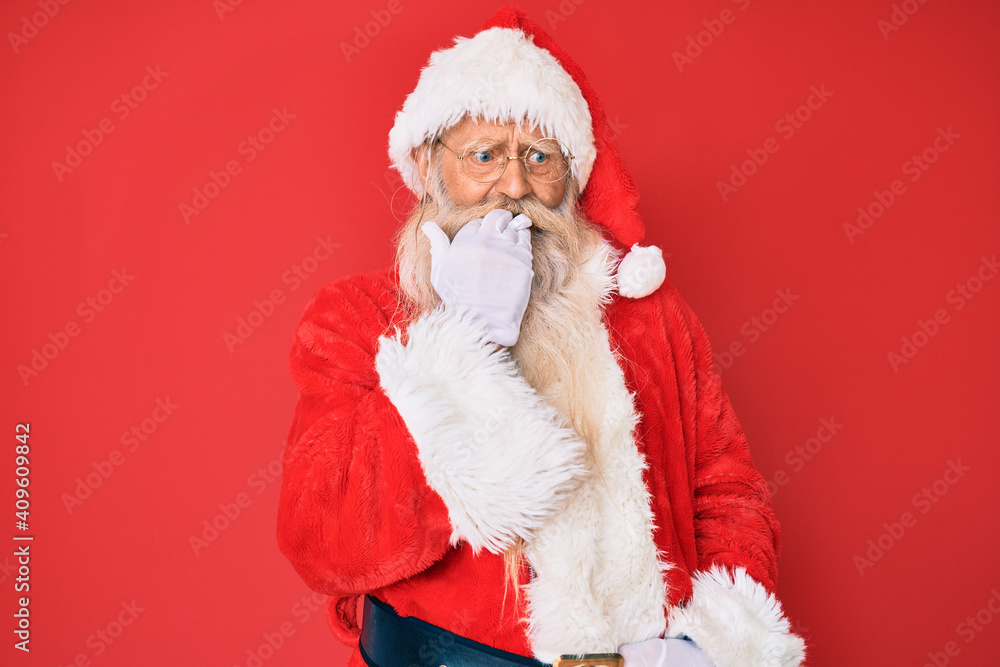 Old senior man with grey hair and long beard wearing traditional santa claus costume looking stressed and nervous with hands on mouth biting nails. anxiety problem. Old senior man with grey hair and long beard wearing traditional santa claus costume looking stressed and nervous with hands on mouth biting nails. anxiety problem.