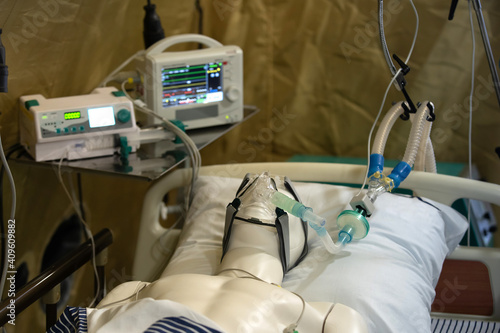 Plastic dummy in an oxygen mask of artificial lung ventilation. The practice of military doctors in a field hospital. Instructions for providing first aid to the victim during hostilities photo